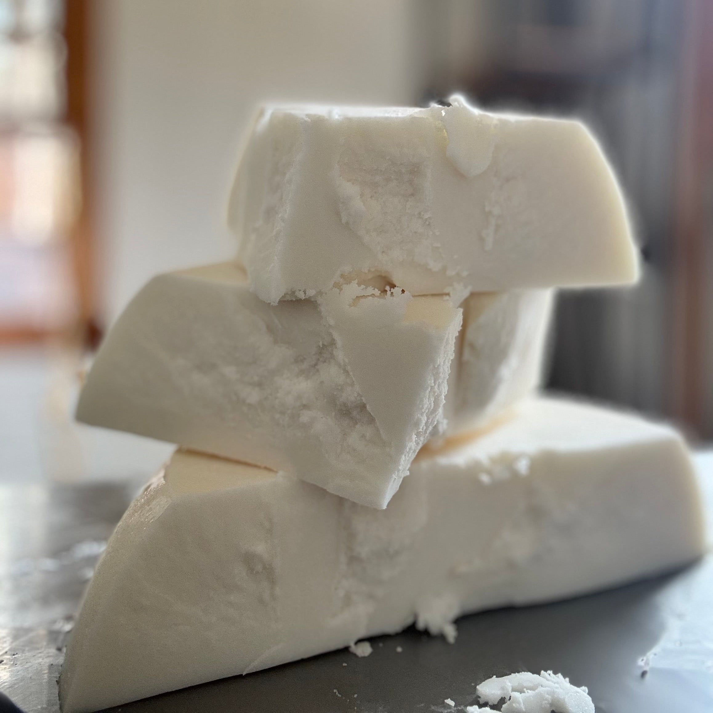 Stack of white blocks on a dark surface with a blurred background
