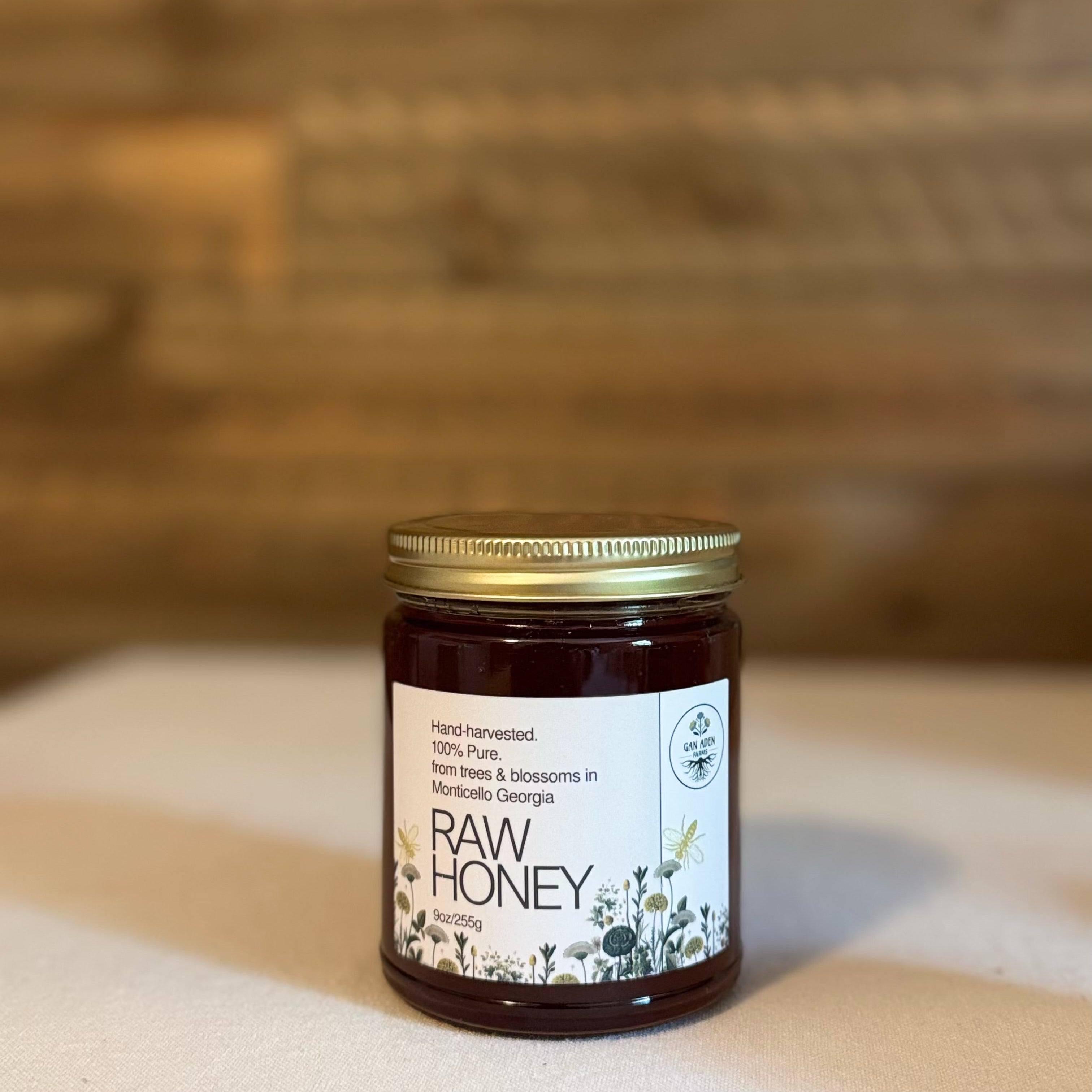 Jar of raw honey on a wooden surface with a blurred background