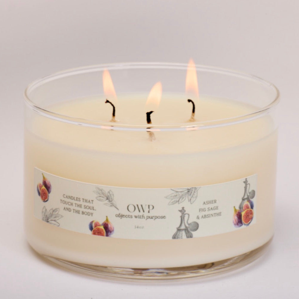Three-wick candle with a label on a light gray background