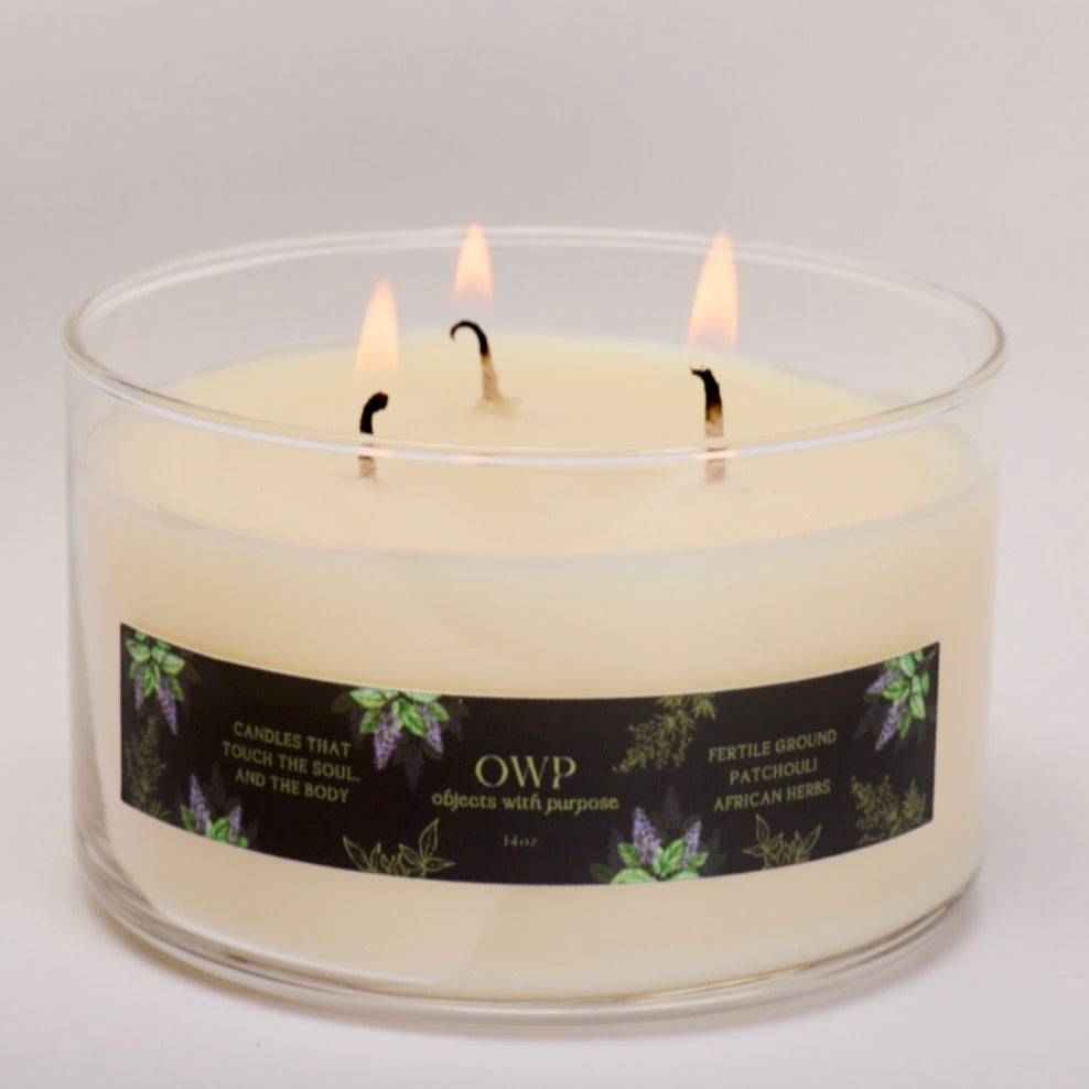 Three-wick candle with a label on a gray background